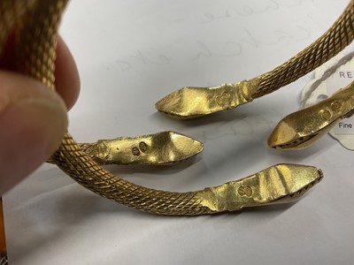 Lot 447 - Pair of eastern yellow metal snake bangles
