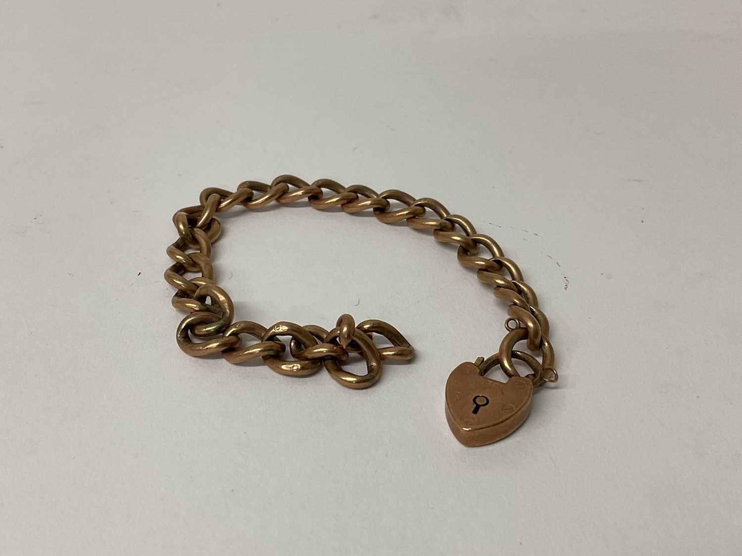 Lot 70 - Late Victorian 9ct rose gold curb link bracelet with heart shaped padlock clasp, (Birmingham 1897).