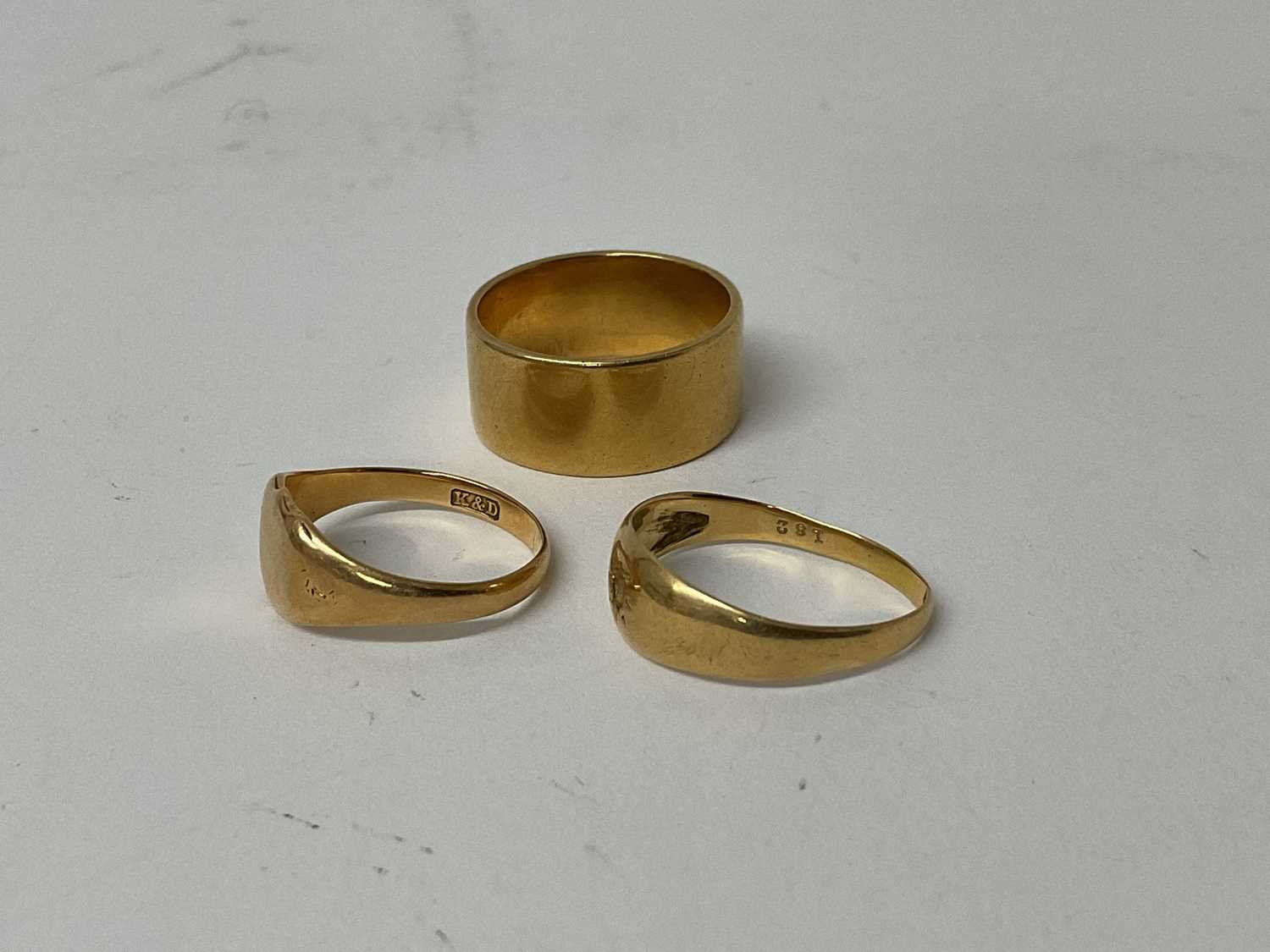 Lot 67 - Edwardian 18ct gold band ring, (London 1908), ring size Q, together with two other 18ct gold rings (3).