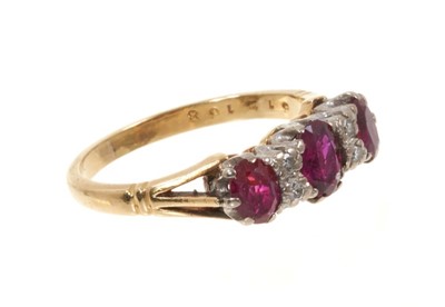 Lot 445 - Ruby and diamond ring with three oval mixed cut rubies and four single cut diamonds in gold claw setting on 18ct yellow gold shank