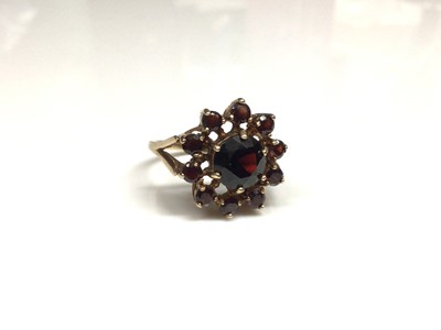 Lot 3 - 9ct gold garnet cluster ring with a flower head cluster of mixed cut garnets in gold claw setting on 9ct gold shank