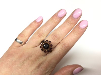 Lot 3 - 9ct gold garnet cluster ring with a flower head cluster of mixed cut garnets in gold claw setting on 9ct gold shank