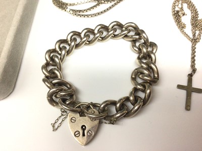Lot 9 - Heavy silver curb link bracelet with padlock clasp, silver locket on chain, cross pendant on chain and a silver box link chain