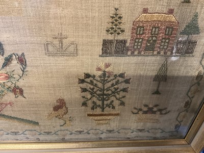 Lot 792 - George IV needlework sampler, by Elizabeth Sandland Aged 14, 1823. A prayer above houses and trees with birds, dog and a large central pot of flowers, all within an acorn border. Gilt frame