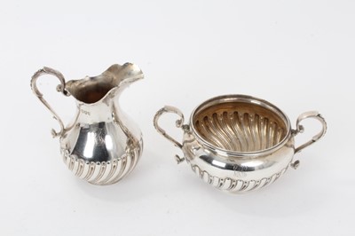 Lot 214 - Victorian silver cream jug and sugar basin of spiral fluted baluster form