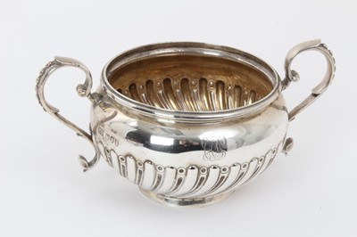 Lot 214 - Victorian silver cream jug and sugar basin of spiral fluted baluster form