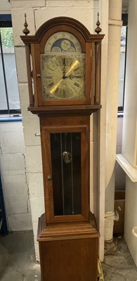 Lot 1171 - Longcase clock with German 8 day chiming movement, arched brass dial with lunar phase, retailed by Fenclocks of Suffolk. With three brass weights and pendulum.