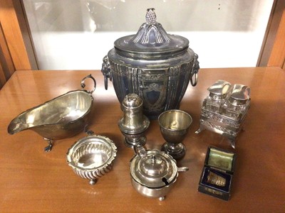 Lot 855 - Small group of silver to include a sauce boat, cruets, egg cup, cased thimble, pair of glass scent bottles in holder and a silver plated tea caddy