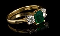 Lot 415 - Emerald and diamond three stone ring, the...