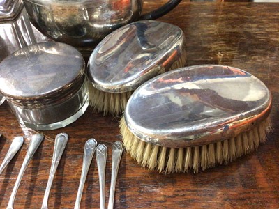 Lot 882 - Group of silver teaspoons, silver topped glass vanity jar, pair of silver backed brushes, plated ware and a Boss bi-metal wristwatch