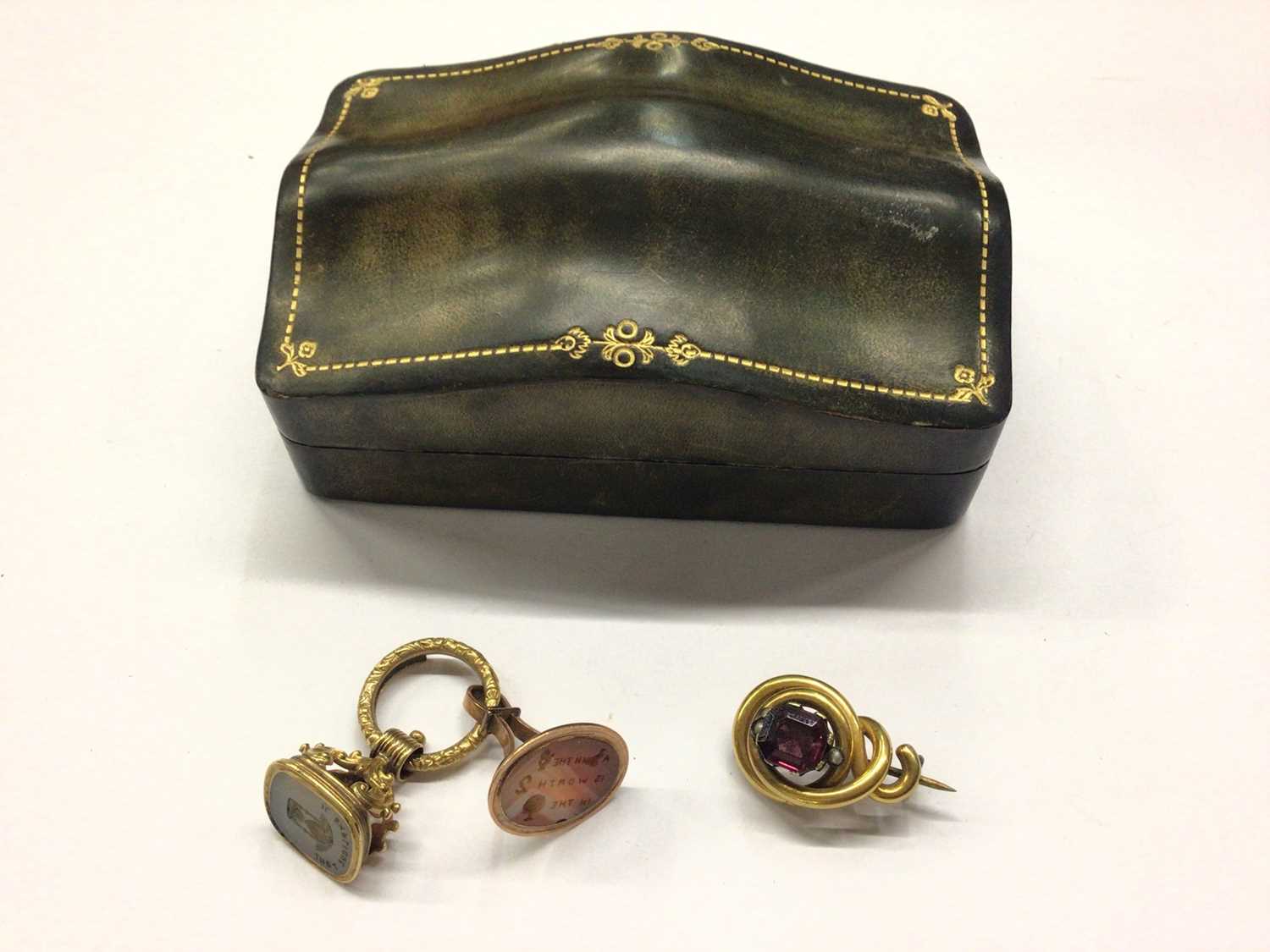 Lot 838 - Two antique seal fobs and a gilt metal brooch, within a small green leather tooled jewellery box