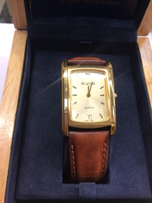 Lot 866 - Two Avia gold plated stainless steel wristwatches on brown leather straps, boxed