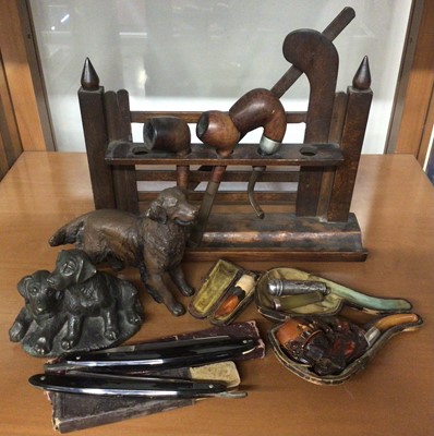 Lot 350 - Wooden pipe rack in the form of a gate, 19th century Meerschaum pipe and others, silver cheroot holder, two cut throat razors and two resin dog ornaments