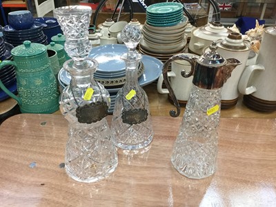 Lot 414 - Two cut glass decanters and claret jug and two silver wine labels