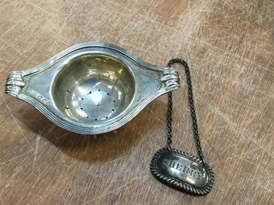 Lot 827 - Silver tea strainer together with a Georgian silver wine label (2)