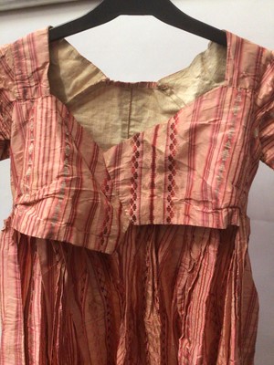 Lot 2050 - Late 18th century / early 19th century Regency pink striped silk open skirt dress with high waist and  cross front and pleated back.