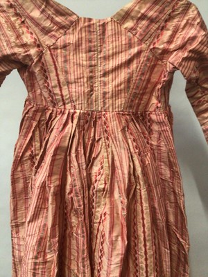 Lot 2050 - Late 18th century / early 19th century Regency pink striped silk open skirt dress with high waist and  cross front and pleated back.