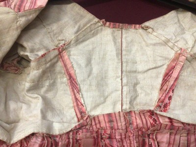 Lot 2050 - Late 18th century / early 19th century Regency pink striped silk open skirt dress with high waist and  cross front and pleated back.