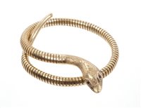 Lot 432 - Gold (9ct) snake bangle with garnet eyes and...