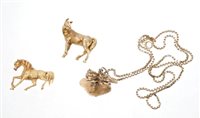 Lot 433 - Gold (9ct) 'horse jumping' pendant on a chain,...