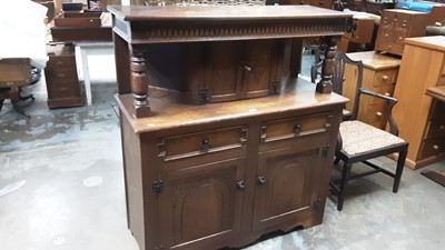 Lot 1070 - Carved oak court cupboard with two carved panelled doors above flanked by turned supports, two drawers and two arched panelled doors below, 122cm wide, 48cm deep, 134cm high