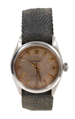 Lot 572 - 1950s Gentlemen's Rolex Oyster wristwatch with champagne dial, gold coloured hour markers and hands in stainless case. On a later canvas bracelet. Case 32mm in diameter.