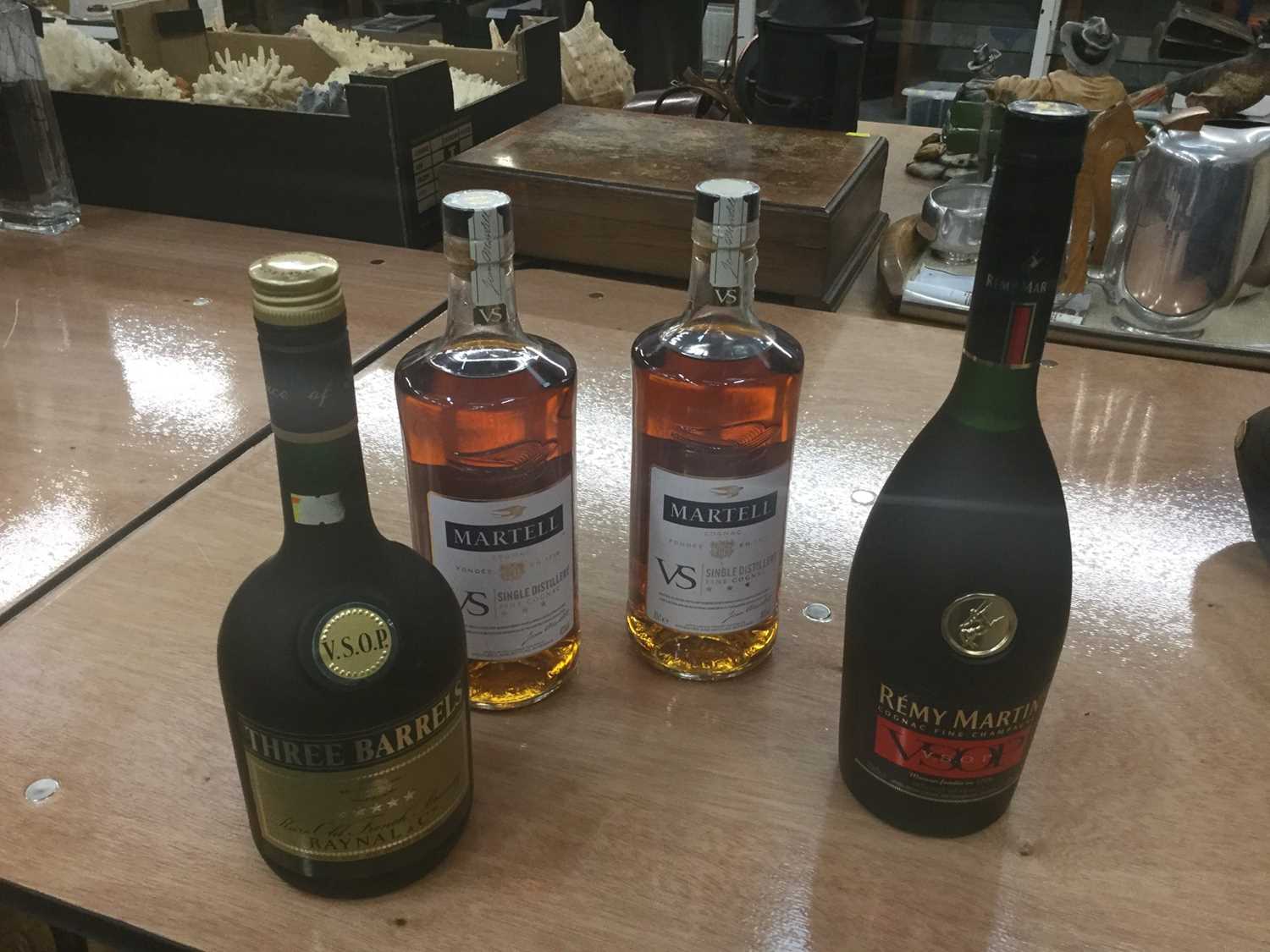 Lot 450 - Cognac and Brandy- two 70cl bottles of Martel VS single distillery cognac, together with a 70cl bottle of Remy Martin Cognac fine champagne and a 68cl bottle of Three Barrels brandy (4)