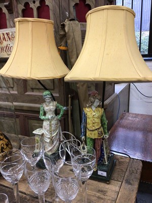 Lot 63 - A pair of continental figural pottery lamps with shades