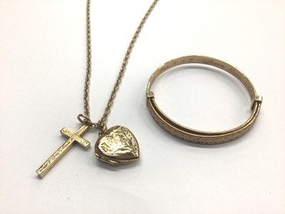 Lot 822 - 9ct gold child's bangle and a 9ct gold chain with heart locket and cross pendant