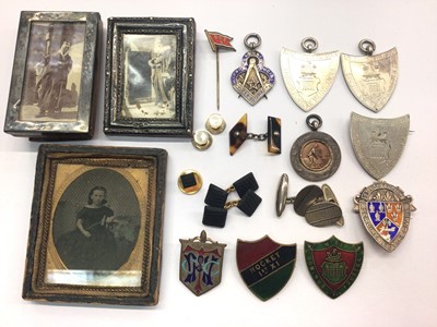 Lot 831 - Two miniature silver photograph frames, silver fobs, enamelled badges and various cufflinks