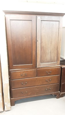 Lot 1095 - 19th century oak linen press with panelled doors above enclosing trays, two short and two long drawers below on bracket feet 198 cm high, 122 cm wide