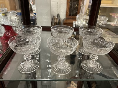 Lot 178 - Set of six vintage cut glass champagne coupes with diamond cut decoration on faceted stems and star cut bases.