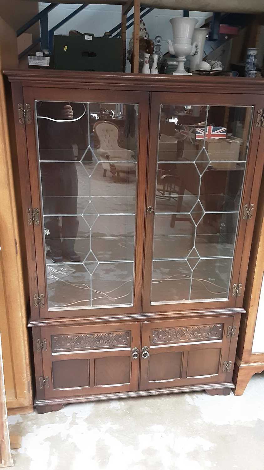 Lot 1117 - Old Charm display cabinet with shelved interior enclosed by two leaded glazed doors, and two carved panelled doors below, 107cm wide, 36.5cm deep, 161cm high