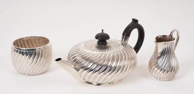Lot 231 - Three-piece Victorian batchelor tea set of wrythen form by Charles Stuart Harris.
