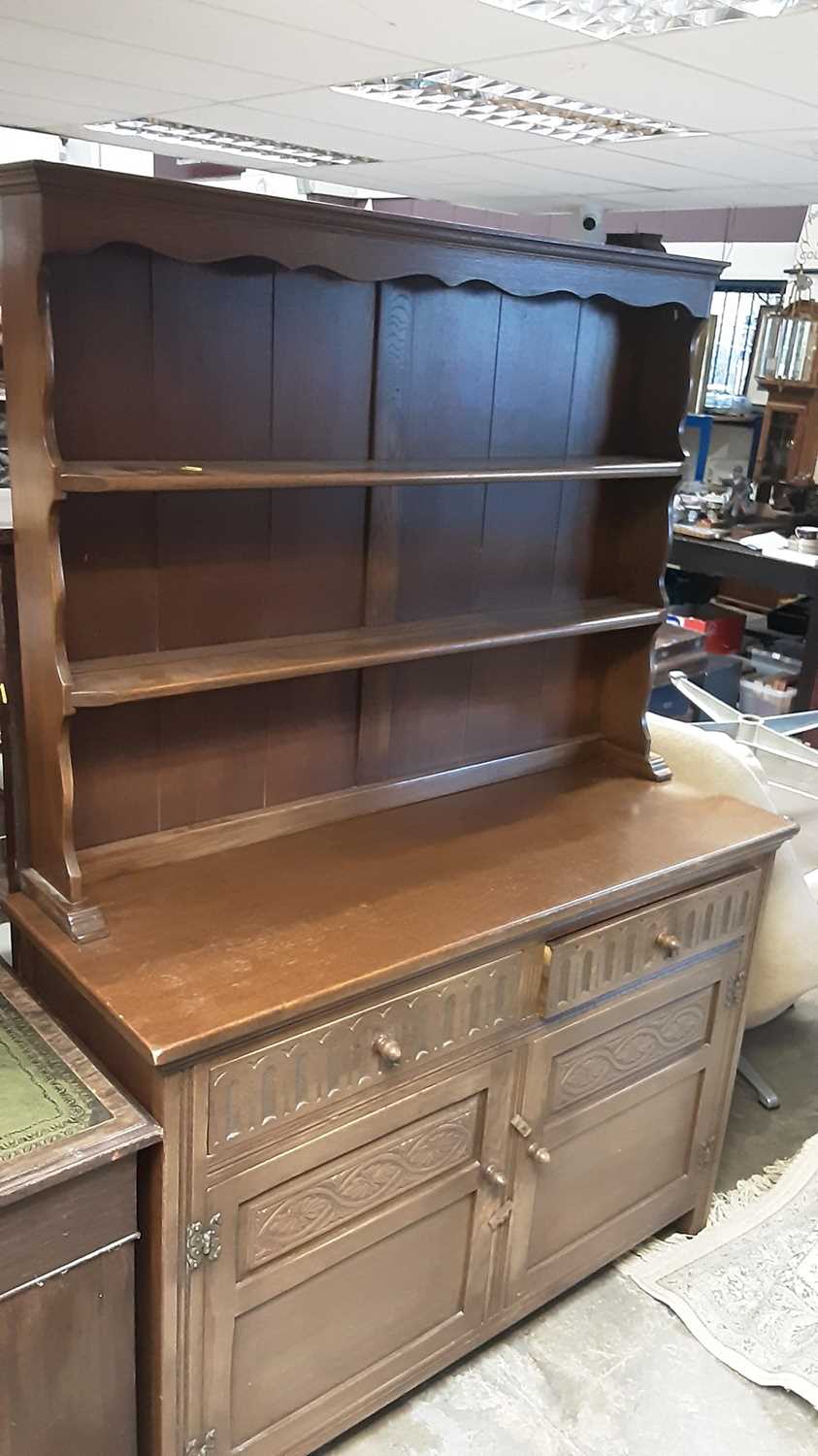 Lot 1145 - JC oak two height dresser with open shelves above, two drawers and two panelled doors below, 122cm wide, 43cm deep, 175cm high