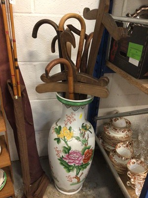 Lot 125 - Japanese porcelain vase filled with walking sticks and wooden swords