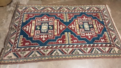 Lot 1194 - Eastern rug with geometric decoration on red, blue and cream ground, 189cm x 122cm