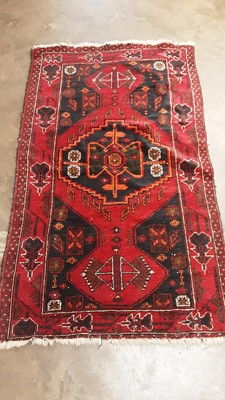 Lot 1196 - Eastern rug with geometric decoration on red, blue and orange ground, 155cm x 89cm