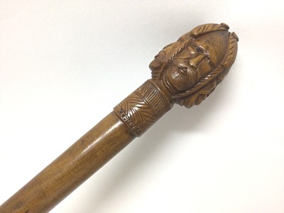 Lot 323 - Walking cane with carved multiple face decoration to the knop