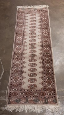 Lot 1206 - Eastern runner with nineteen central medallions on beige ground, 75cm x 63cm