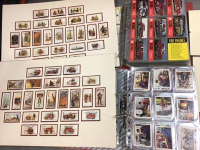 Lot 327 - Collection of mainly fire engine related trading cards within two folders, together with fire engine cigarette cards in mounts and two glazed pictures