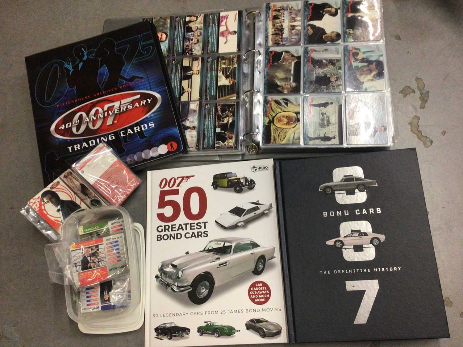 Lot 325 - Collection of James Bond 007 trading cards, within two folders, plus some loose and two Bond cars books