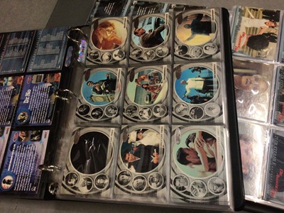 Lot 325 - Collection of James Bond 007 trading cards, within two folders, plus some loose and two Bond cars books