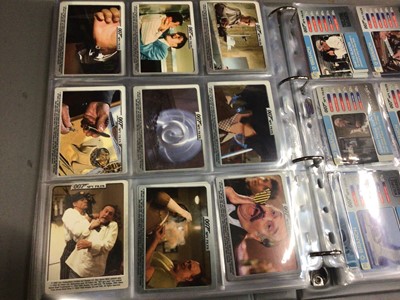 Lot 325 - Collection of James Bond 007 trading cards, within two folders, plus some loose and two Bond cars books