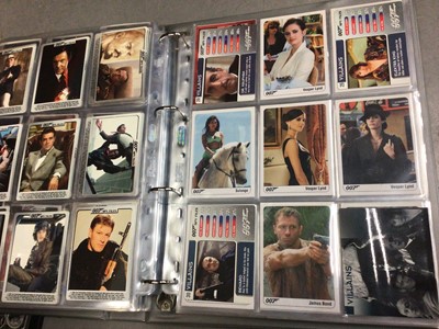 Lot 325 - Collection of James Bond 007 trading cards, within two folders, plus some loose and two Bond cars books