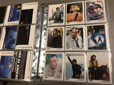 Lot 325 - Collection of James Bond 007 trading cards, within two folders, plus some loose and two Bond cars books