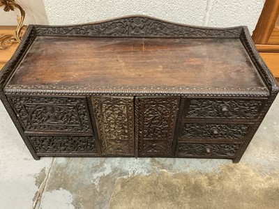 Lot 352 - Ornate Indian carved table cabinet, with arrangement of cupboards and drawers and secret drawers, 60cm wide