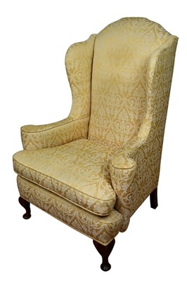 Lot 1342 - Early 20th century wing armchair with gold upholstery