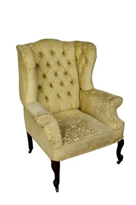 Lot 1346 - George II style wing armchair, on carved legs and castors