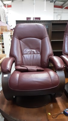 Lot 1031 - Contemporary leather reclining armchair with matching footstool